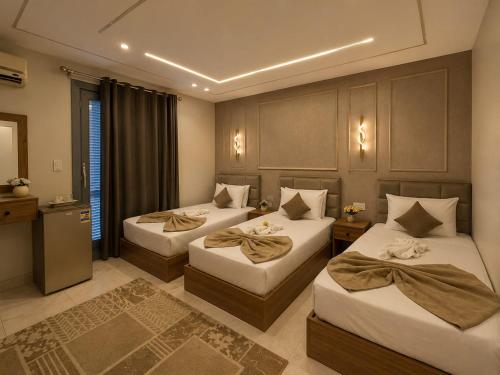 a bedroom with two beds in a room at Garden Hotel Nile House in Cairo