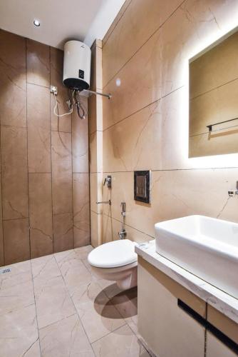a bathroom with a toilet and a sink and a mirror at HOTEL La VILLA in Amritsar