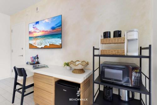 a room with a desk with a microwave and a tv at Pininfarina Studio Intracoastal View in Hallandale Beach