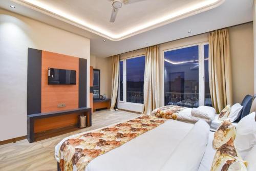 a hotel room with a bed and a large window at HOTEL La VILLA in Amritsar