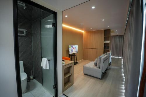 a bathroom with a toilet and a couch in a room at Sea Side Resort in Paje