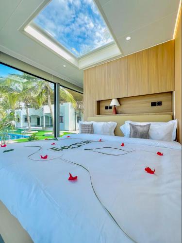 a bedroom with a large bed with red roses on it at Sea Side Resort in Paje