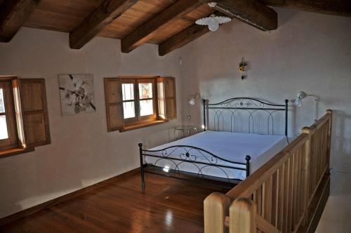 a bedroom with a bed and a staircase with windows at Agriturismo l'Arbo in Andorno Micca