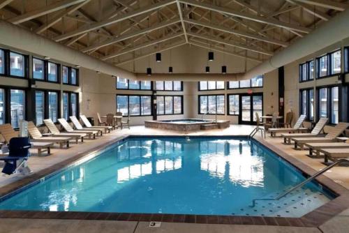 a large swimming pool with chairs and a table at Laurel Point Resort in Gatlinburg