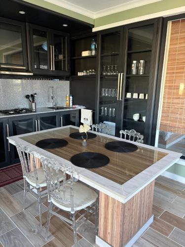 a kitchen with a large island with chairs around it at Appartement Zen VIP Péreybère in Grand-Baie