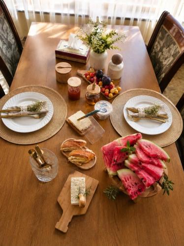 a wooden table with plates of food on it at Syuzn Resort in Goris