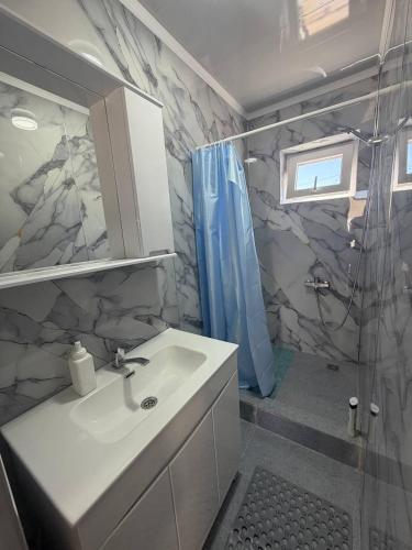 a bathroom with a sink and a shower at Naryn Guest House in Naryn