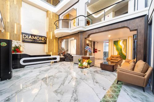 a lobby of a building with a marble floor at Diamond Hotel in Bien Hoa