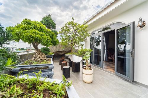 a garden with trees and plants on a patio at Diamond Hotel in Bien Hoa