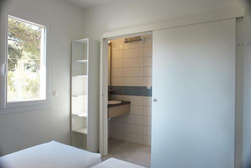 a bathroom with a toilet and a sink at Appartements des Joncas in Martigues