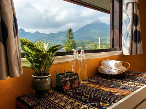 a table with a window with a view of a mountain at Mộc An SaPa Home in Sapa