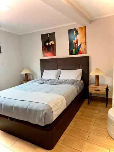 a bedroom with a large bed and two lamps at Sea View Pedra Mar in Campanário