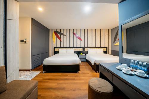 a hotel room with two beds and a table at Le House Boutique Hotel - 100m to the beach in Danang