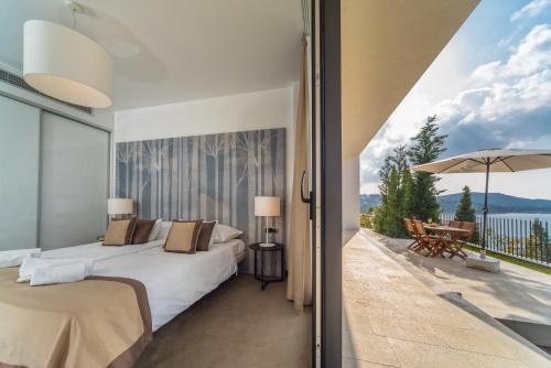 a bedroom with two beds and a balcony with a view at Golden Rays Luxury Villas & Apartments in Primošten