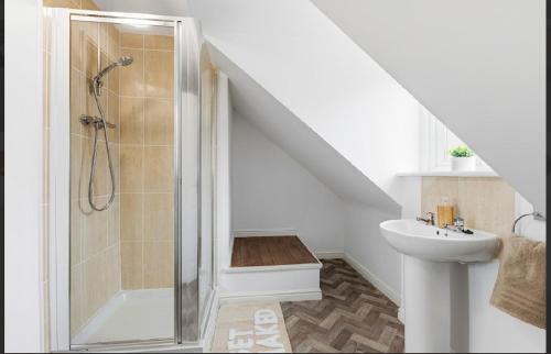 a bathroom with a shower and a sink at Home Comforts Await! 3bed 2.5bath in Ellesmere Port