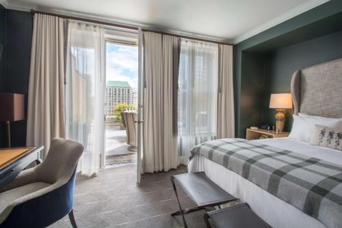 a hotel room with a bed and a balcony at Sentinel Hotel in Portland