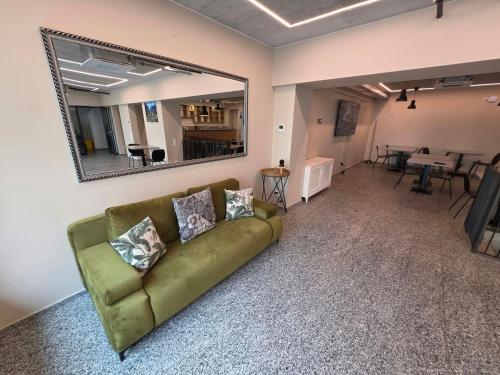 a living room with a couch and a mirror at Regina by GoAcademy in Agno