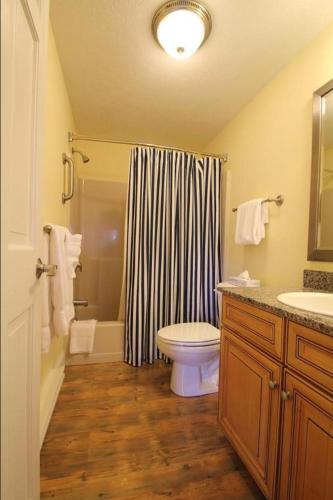 a bathroom with a toilet and a shower and a sink at Nautical Mile Resort in Wells