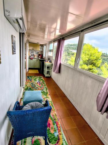 a room with a table and a chair and a rug at Athena in Camporosso