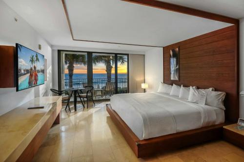 a bedroom with a bed and a view of the ocean at Costa d'Este Beach Resort & Spa in Vero Beach