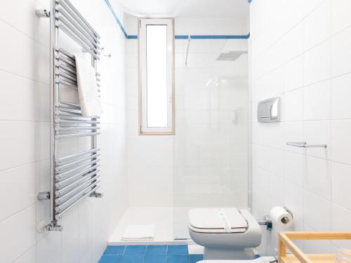 a white bathroom with a toilet and a window at Dadu 150 in Bari