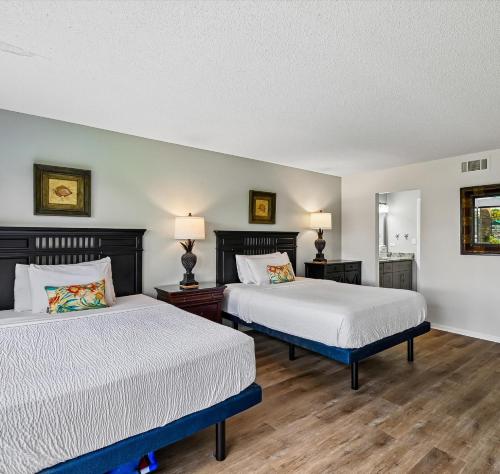 a bedroom with two beds and two lamps at Edgewater Villa #2604 in Panama City Beach