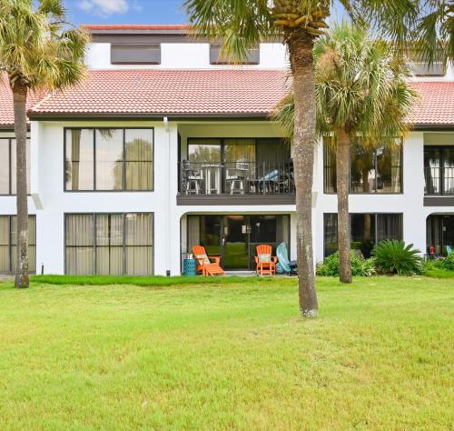 a house with palm trees in front of it at Edgewater Villa #2604 in Panama City Beach