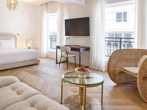 a living room with a bed and a table at ATHENA Pallas in Athens
