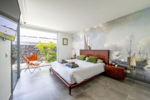 a bedroom with a bed and a large window at Villa Veiga with heated pool in Callao Salvaje