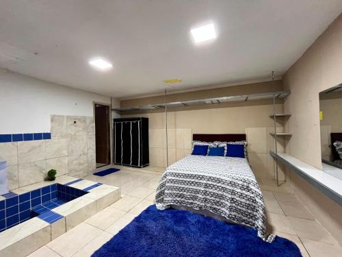 a bedroom with a bed and a bath tub at Chacará Village do Rio Ouro in Conde