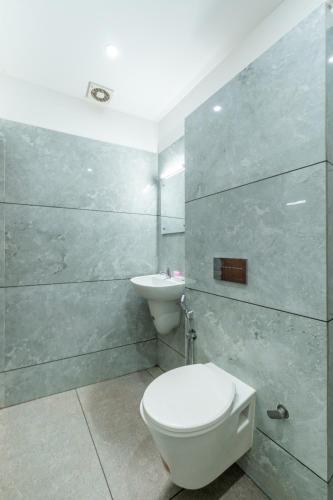 a bathroom with a toilet and a sink at Hotel Faaz international in Thottada