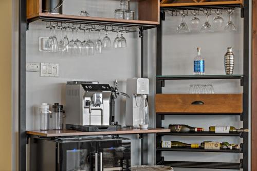 a kitchen with a counter with glasses on the wall at Tremblant Prestige - Altitude 170-1 in Mont-Tremblant