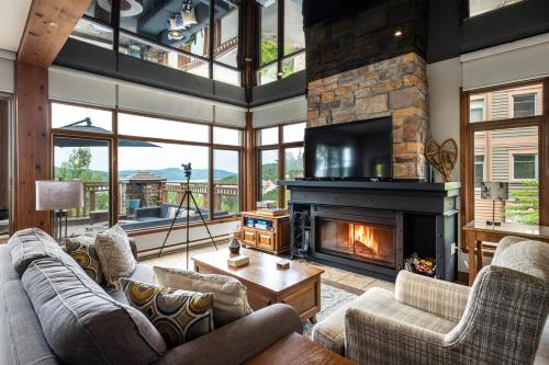 a living room with couches and a fireplace at Tremblant Prestige - Altitude 170-1 in Mont-Tremblant