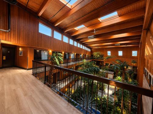 a large building with a balcony with plants at Super 8 by Wyndham Prince George in Prince George