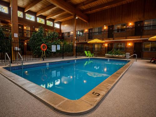 a large swimming pool in a hotel building at Super 8 by Wyndham Prince George in Prince George