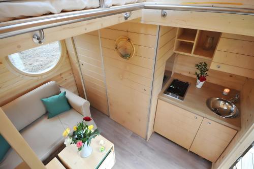 an overhead view of a small kitchen in a tiny house at Cabane Le Carré D'étoiles in Voussac