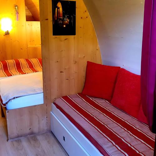 a bedroom with two beds in a cabin at La Cabane Forestière in Voussac
