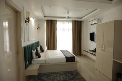 a hotel room with a bed and a window at The Woods by CASA D' GAVA in Lucknow