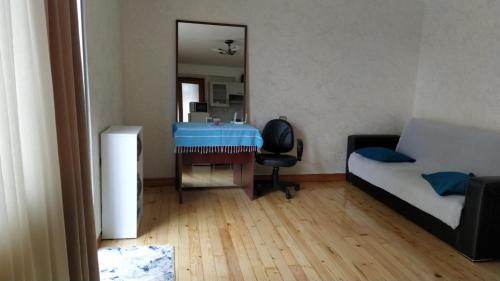 a small room with a desk and a bed at Anas apartments in Zugdidi
