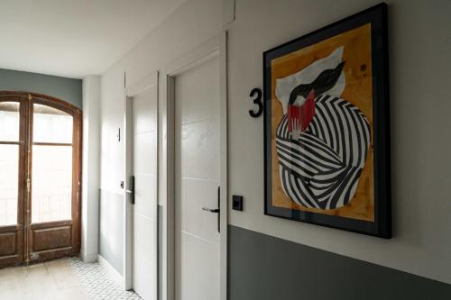 a hallway with a painting of a chicken on the wall at El Convento in Molina de Aragón
