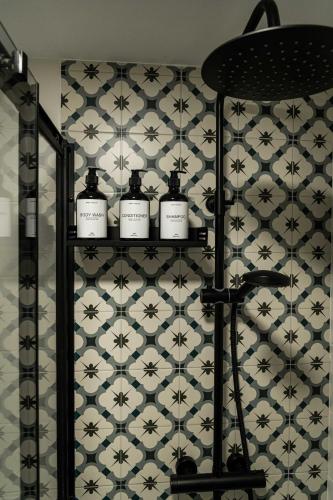 a bathroom with a shelf with four candles on a wall at El Convento in Molina de Aragón