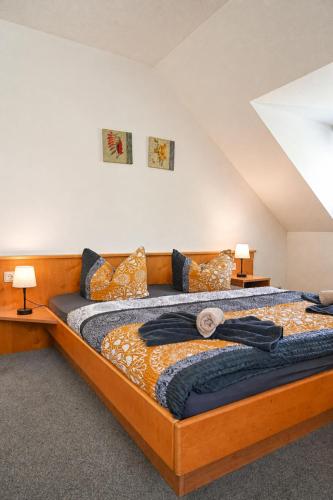 a large bed in a room with two lamps at Landhotel Peters - zwischen zwei Seen in Canow