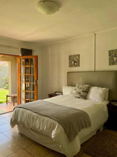 a bedroom with a large bed in a room at Lapaleholo Guesthouse in Phuthaditjhaba