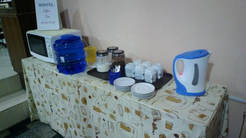 a table with a microwave and bottles of water on it at Hua Hin Euro City Hotel in Hua Hin