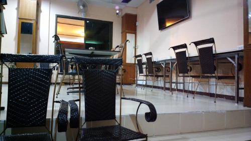 a group of chairs and a table in a room at Hua Hin Euro City Hotel in Hua Hin