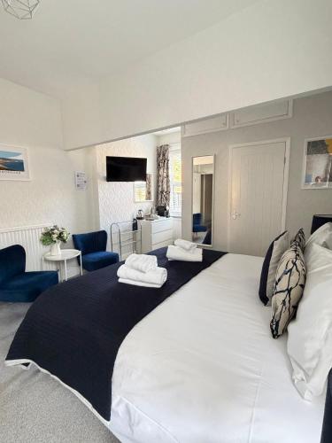 a large white bed with two pillows on top of it at Kingsway Guesthouse - A selection of Single, Double and Family Rooms in a Central Location in Scarborough