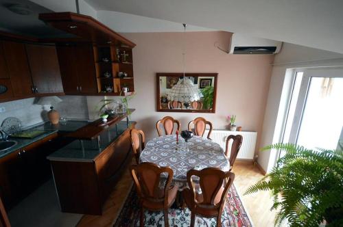 a kitchen with a table and chairs in a kitchen at T&A Apartments in Ohrid