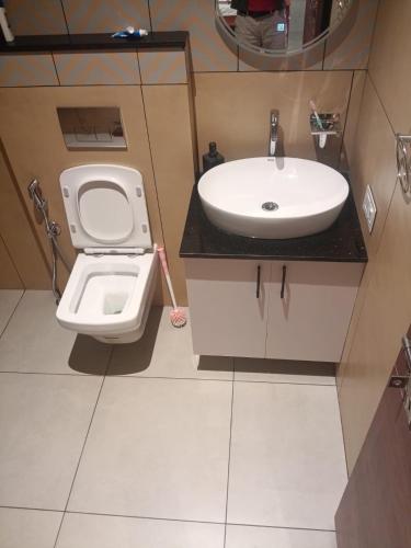 a bathroom with a toilet and a sink at Coorg Family Villa in Gonikoppal