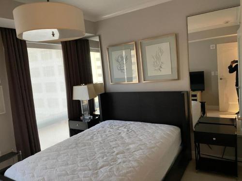 a bedroom with a bed and a large mirror at Hotel House 1 in Abuja