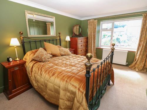 a bedroom with a large bed and a mirror at Banklands in Barnard Castle
